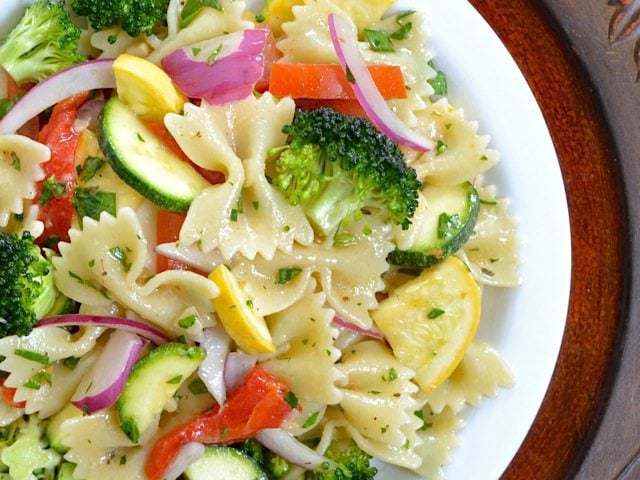 This light and fresh Summer Vegetable Pasta Salad is a great way to use up those plentiful summer vegetables! BudgetBytes.com