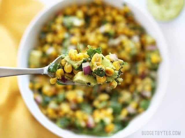 Warm Corn and Avocado Salad makes the perfect light and fresh side for enchiladas, grilled meats, or tacos. BudgetBytes.com