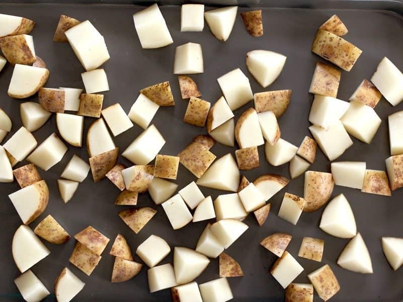 Cubed Russet Potatoes on a baking sheet