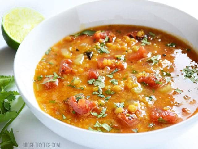 Mexican Red Lentil Stew placed in white bowl - BudgetBytes.com