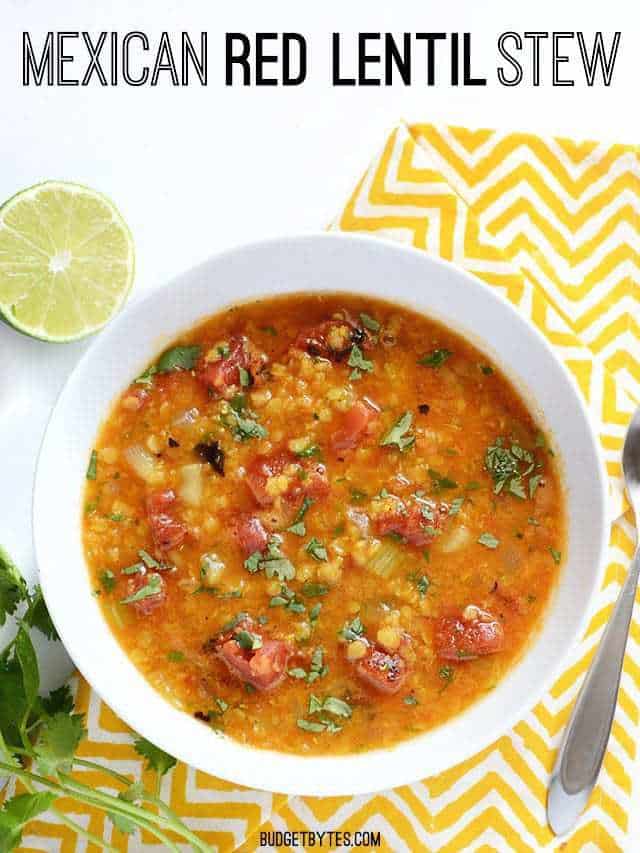 Mexican Red Lentil Stew placed in white bowl with lime slice and parsley on side 