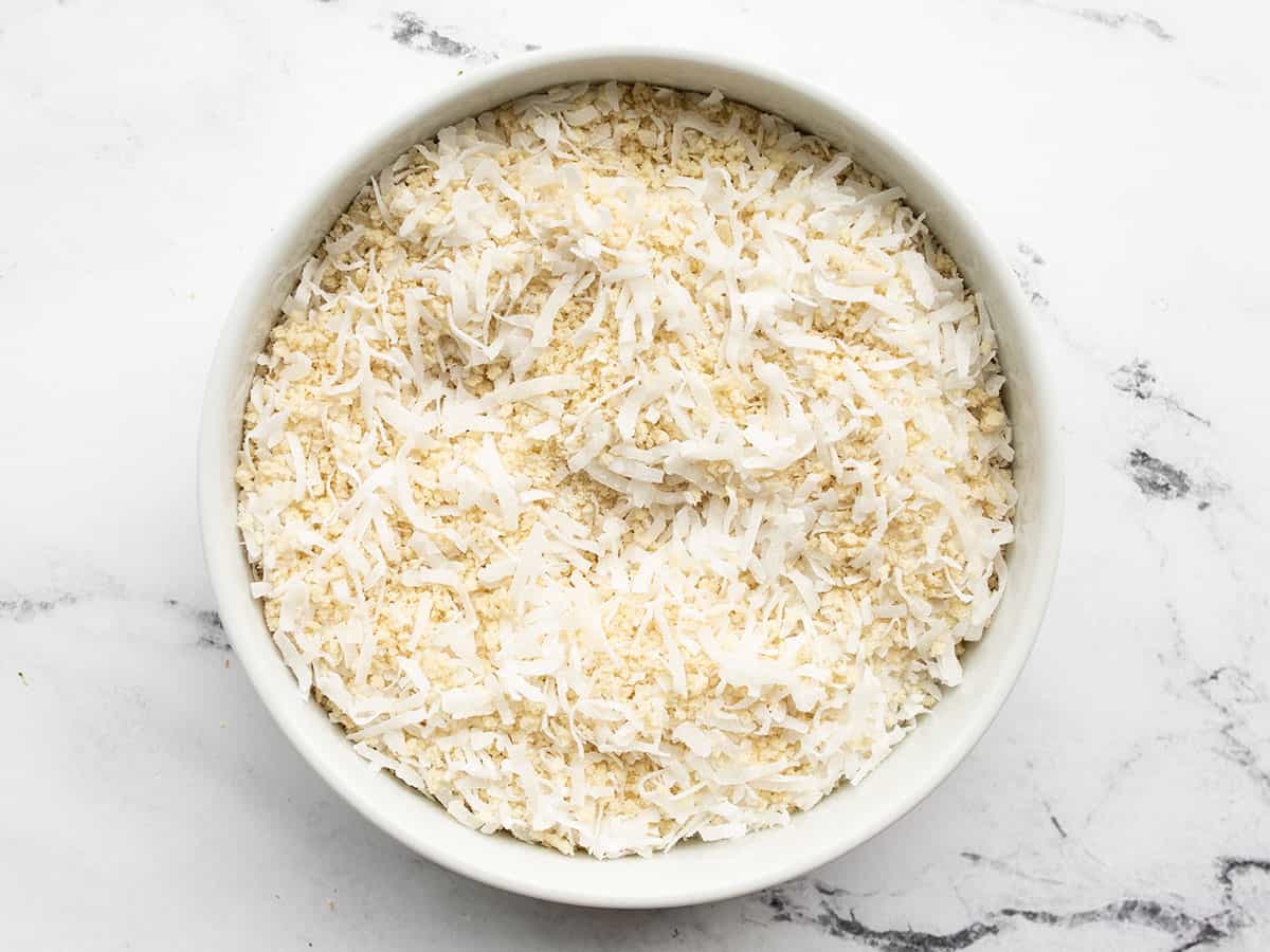 Coconut and panko breadcrumbs mixed together in a bowl