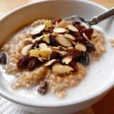 Bowl of Indian-style oats garnished with spices and milk.