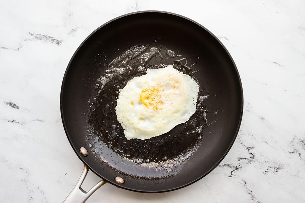 Fried egg in a skillet with butter