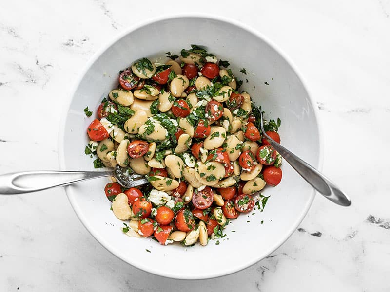 Stirred salad in a bowl with two forks