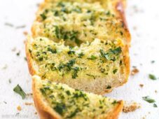 Homemade Garlic Bread is twice as nice for half the price of it's frozen store bought counterpart! Plus it only takes minute to make and can be stored, unbaked, in the freezer. BudgetBytes.com