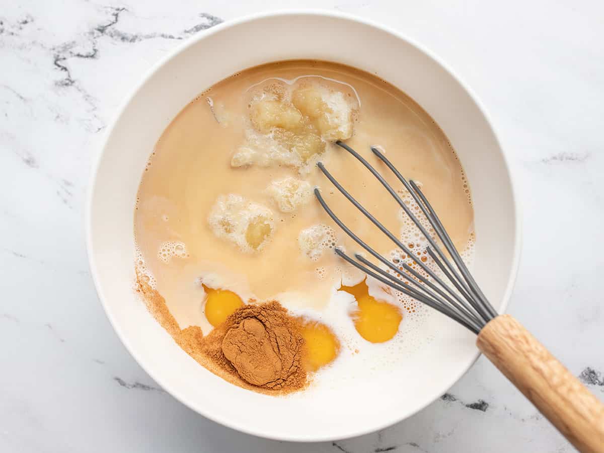 Custard ingredients in a bowl with a whisk