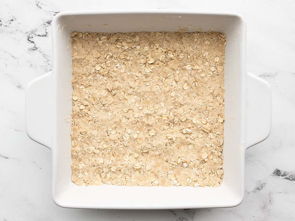 Oat mixture pressed into the bottom of the baking dish