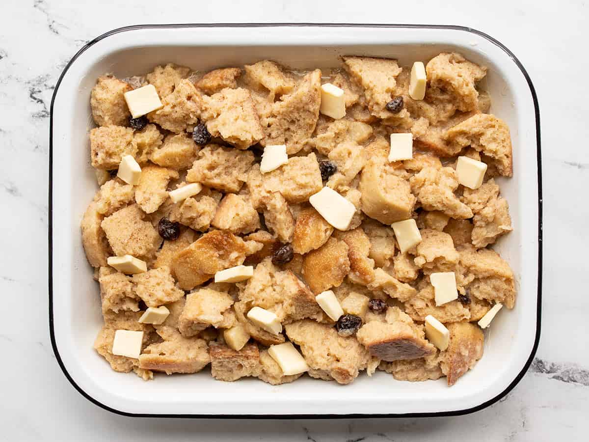 Bread pudding in the casserole dish topped with butter