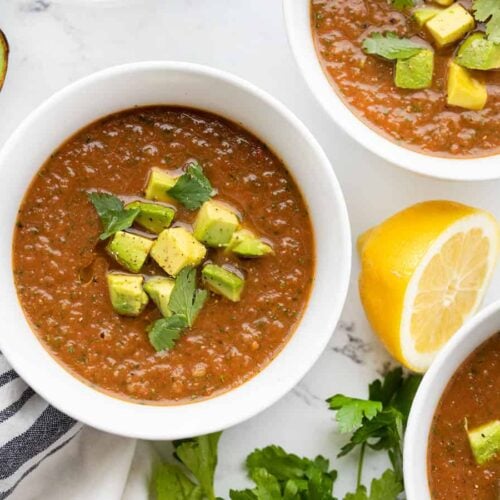 Overhead view of three bowls of summer gazpacho