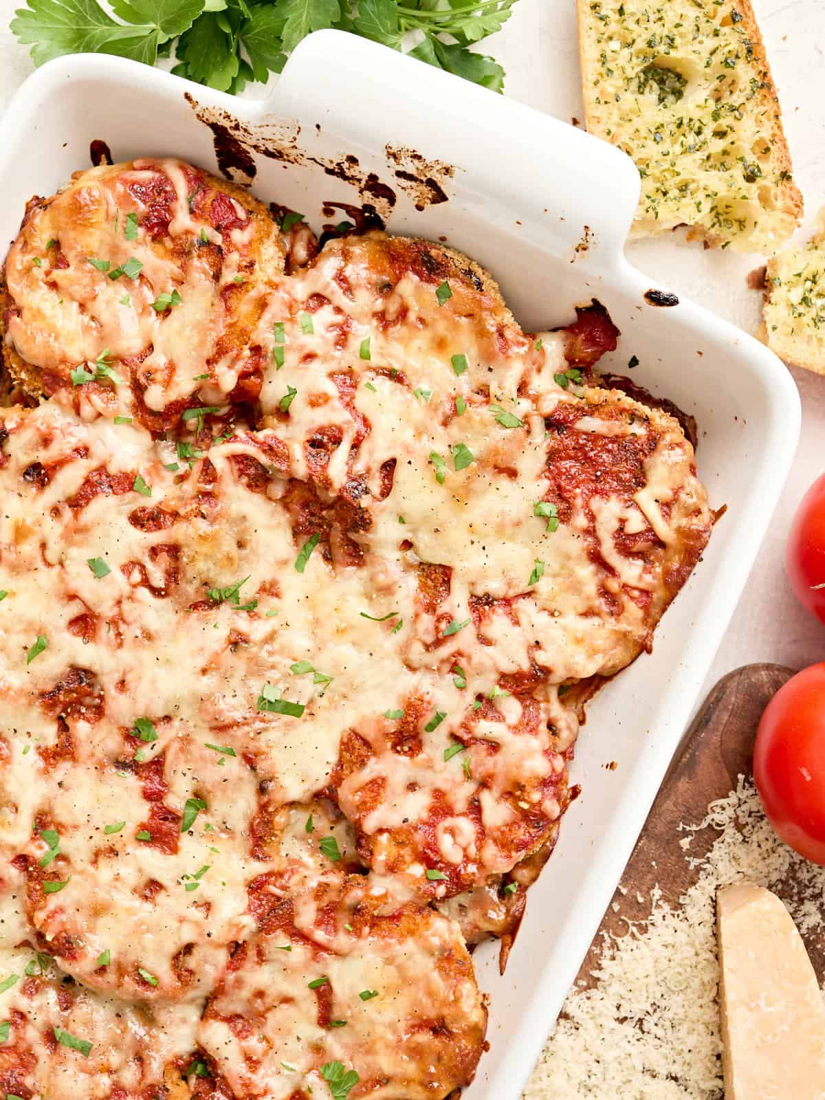 Overhead view of an eggplant parmesan in a baking dish.