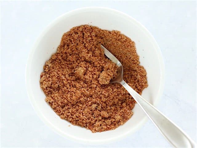 Brown Sugar Spice Mix for Glazed Pork Chops in white bowl with spoon 