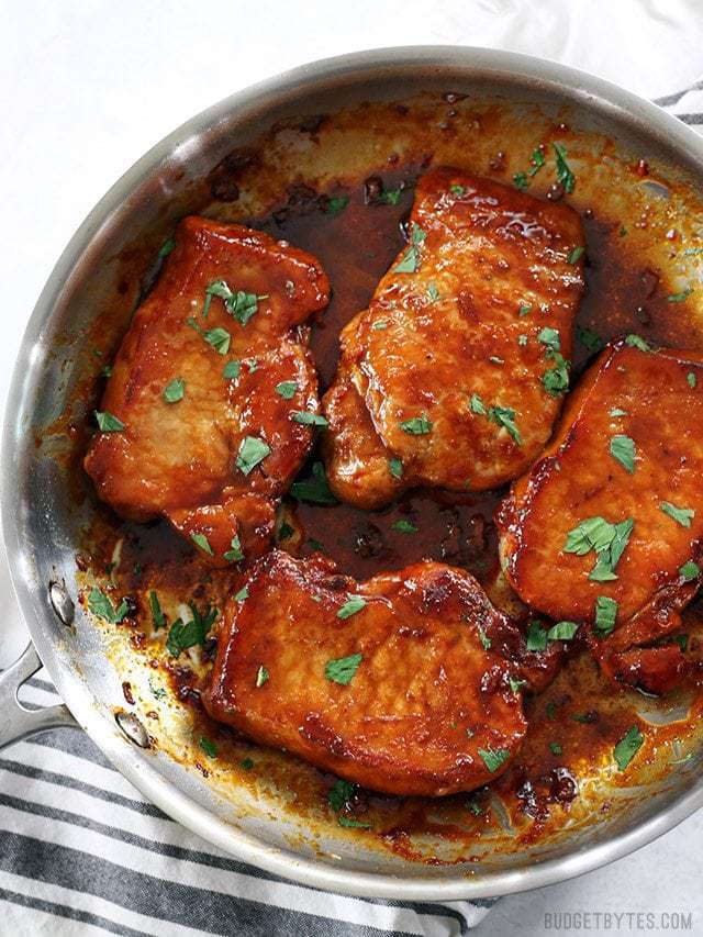 Full shot of tender juicy Glazed Pork Chops in the skillet.