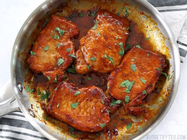 These juicy Glazed Pork Chops are sweet, salty, and a little spicy. The sugar glaze helps keep the chops moist and tender! Budgetbytes.com Tender juicy Glazed Pork Chops in the skillet