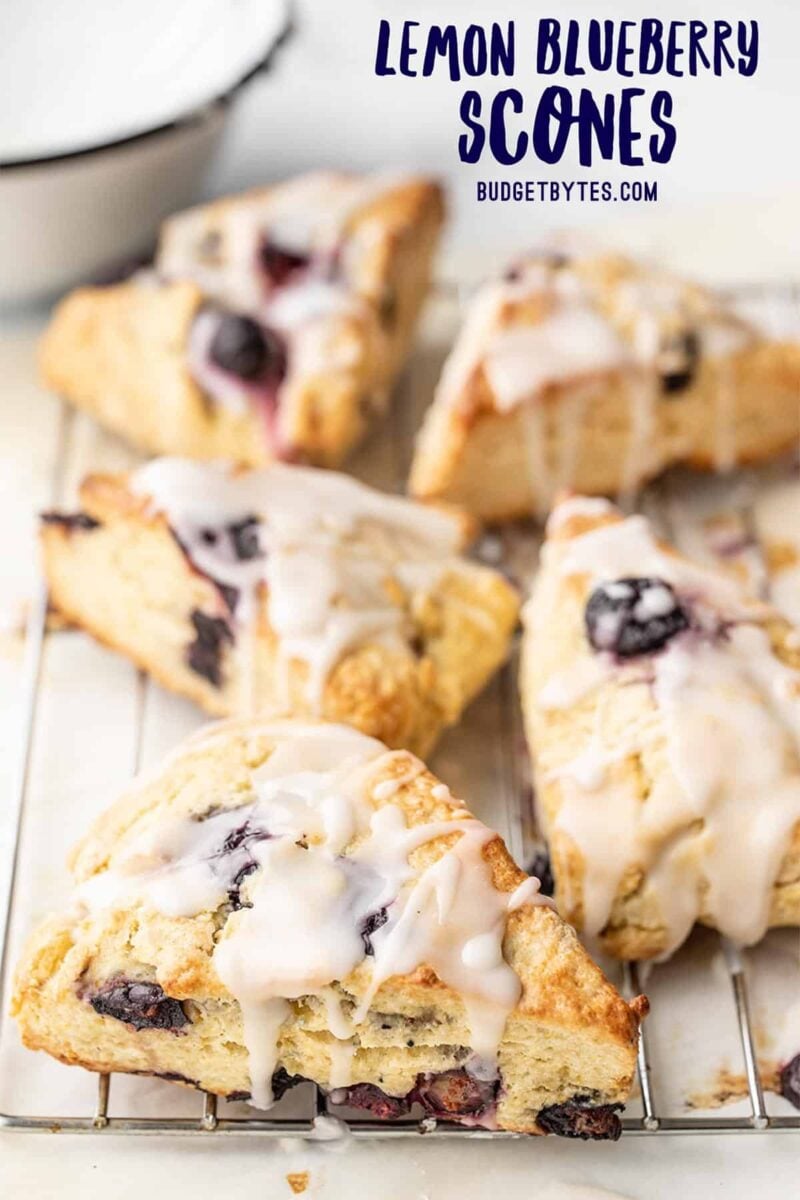 side view of lemon blueberry scones on a cooling rack, title text at the top