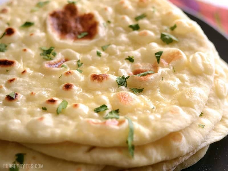 Close up of the browned bubbles on homemade naan bread.