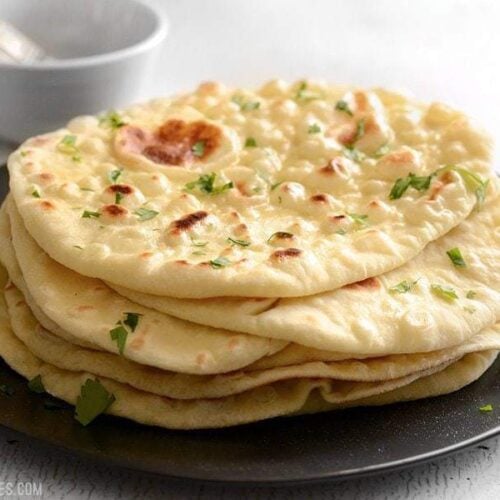 Soft, pillowy, homemade naan is easier to make than you think and it's great for sandwiches, pizza, dipping, and more. BudgetBytes.com