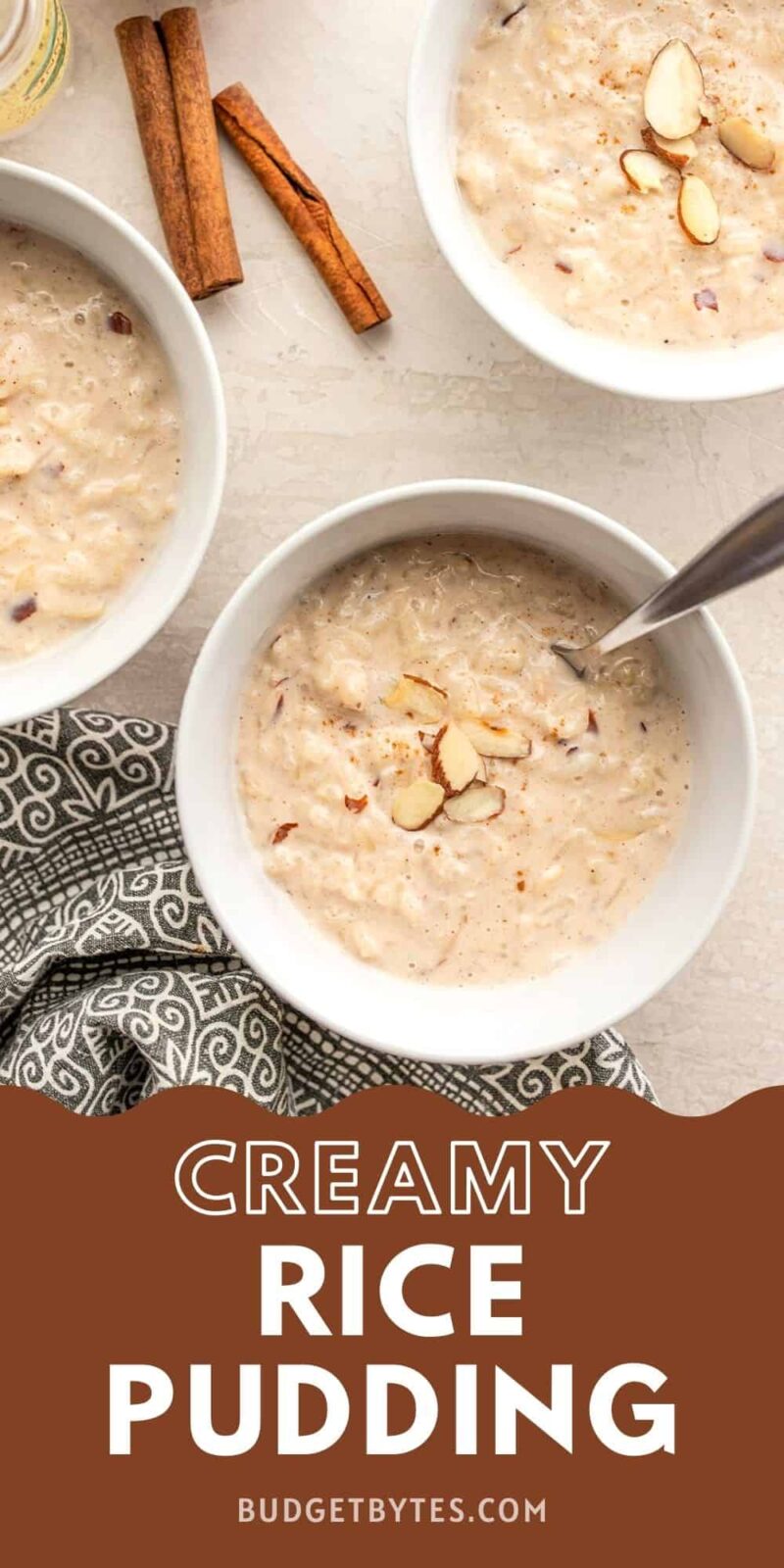 Three bowls of rice pudding garnished with almonds.