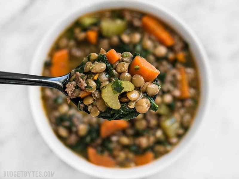 close up of Lentil & Sausage Stew on spoon