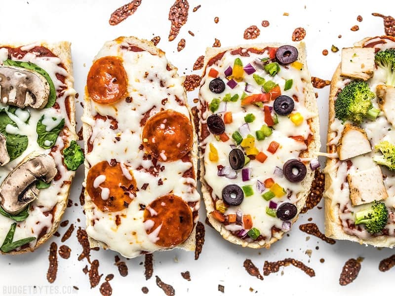 Close up of four French Bread Pizzas on a baking sheet