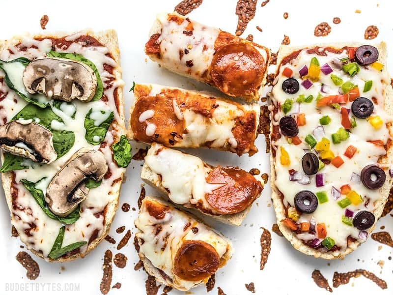 Close up of baked French Bread Pizza with one sliced into pieces