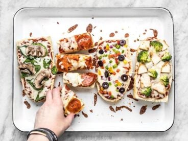 French Bread Pizza is the perfect budget-friendly fast and easy weeknight dinner. Customize the toppings to fit your taste buds or what you have on hand! Budgetbytes.com
