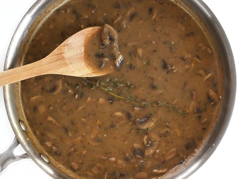 gravy in pan finished cooking with wooden spoon