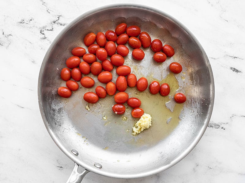 Grape tomatoes and garlic in the skillet