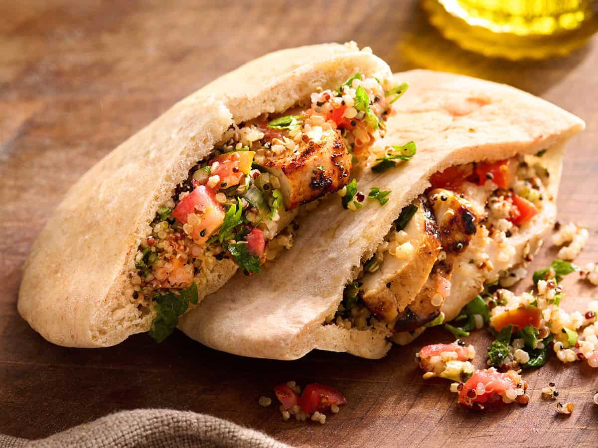 A homemade pita bread stuffed with a chicken grain salad.