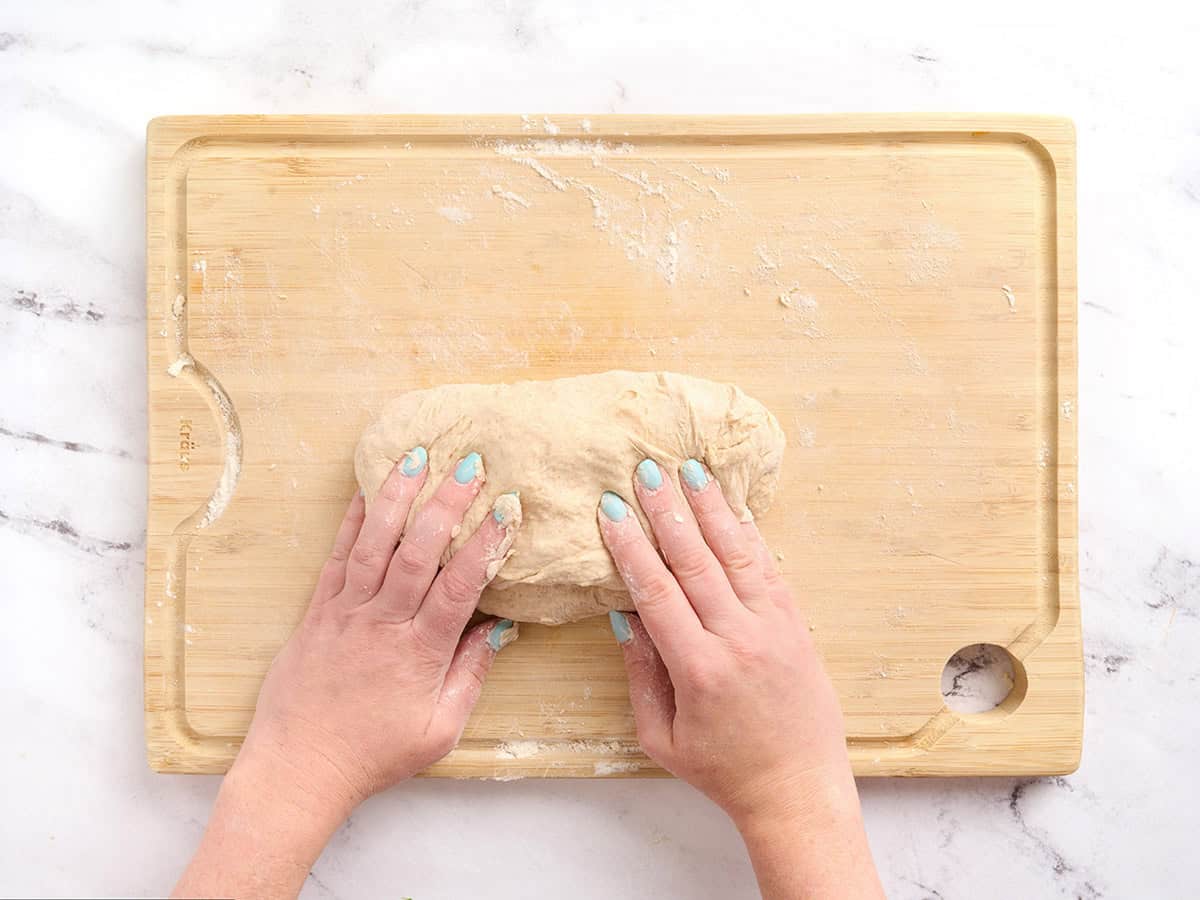 Hands kneading dough.