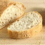 Sliced no-knead ciabatta loaf on a cutting board.
