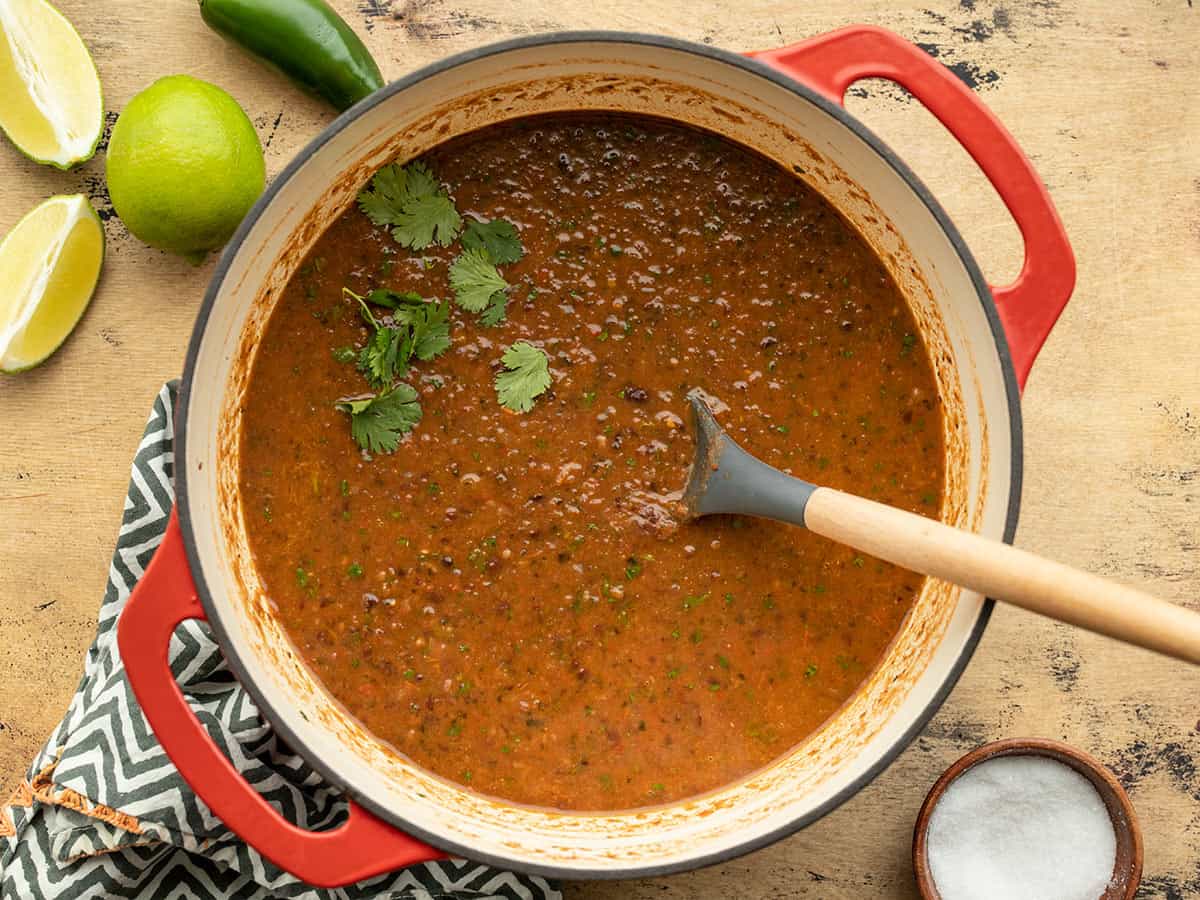 black bean and roasted salsa soup in a Dutch oven garnished with cilantro