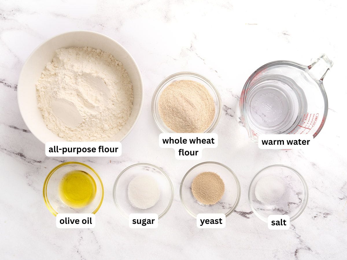 The ingredients to make homemade pita bread with labels.