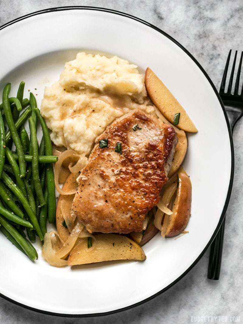 Apple Spice Pork Chops on a plate with mashed potatoes and green beans