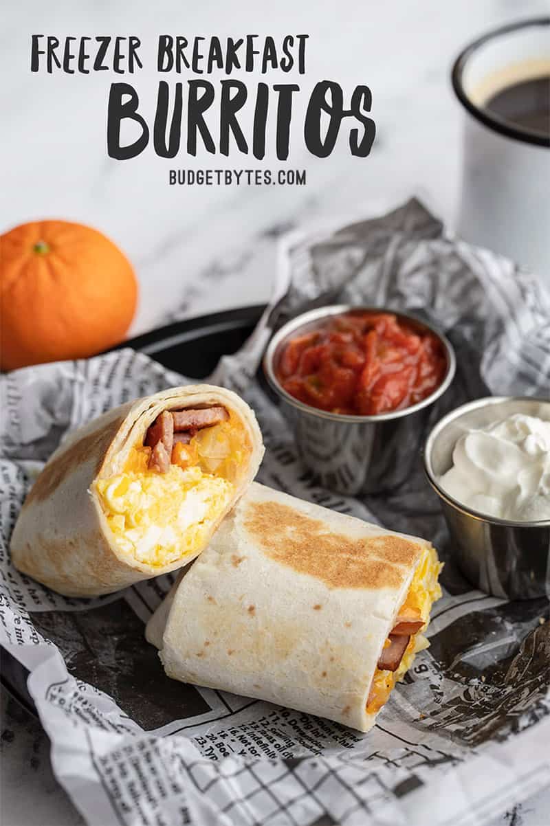 A breakfast burrito on a plate next to dishes of salsa and sour cream, title text at the top