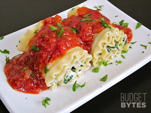 Two Spinach Lasagna Roll Ups plated on white plate ready to serve 