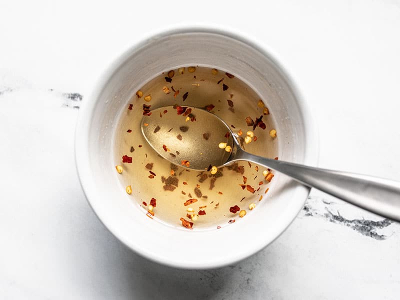 Cucumber Mango Salad Dressing in a small bowl with a spoon