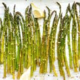 Close up overhead shot of lemon garlic roasted asparagus on the sheet pan