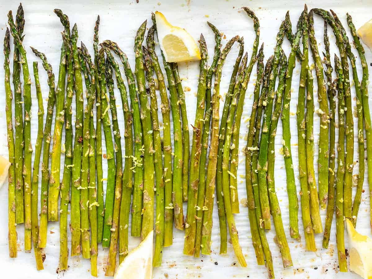 Close up overhead shot of lemon garlic roasted asparagus on the sheet pan