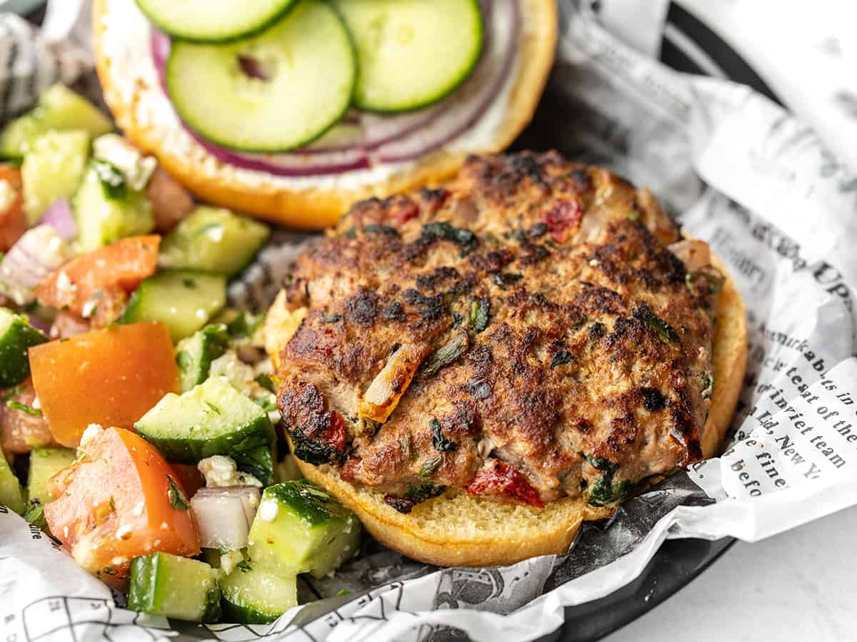 Close up side view of a mediterranean turkey burger, open-faced