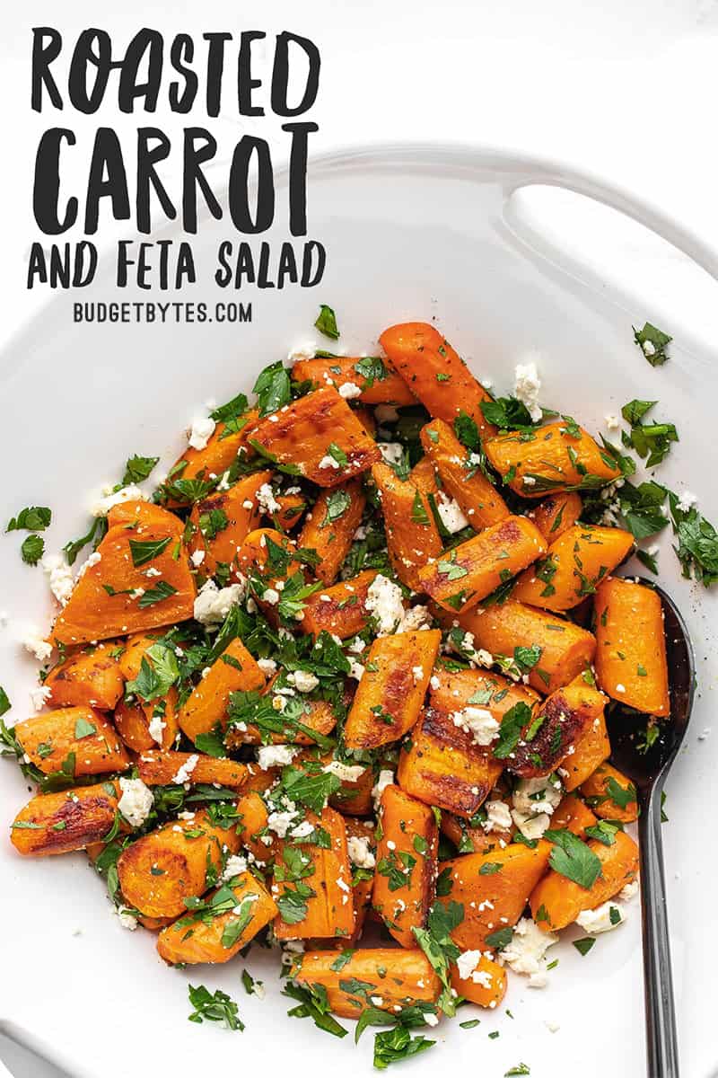 Overhead view of roasted carrot and feta salad in a white serving dish, title text at the top