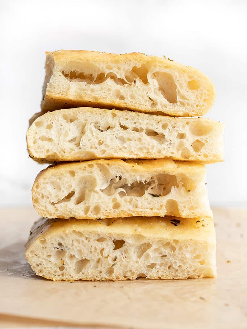 A stack of focaccia slices, sides visible showing off bubbles