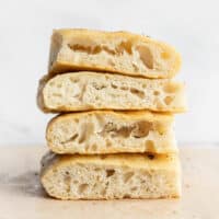 A stack of no knead focaccia slices viewed from the side