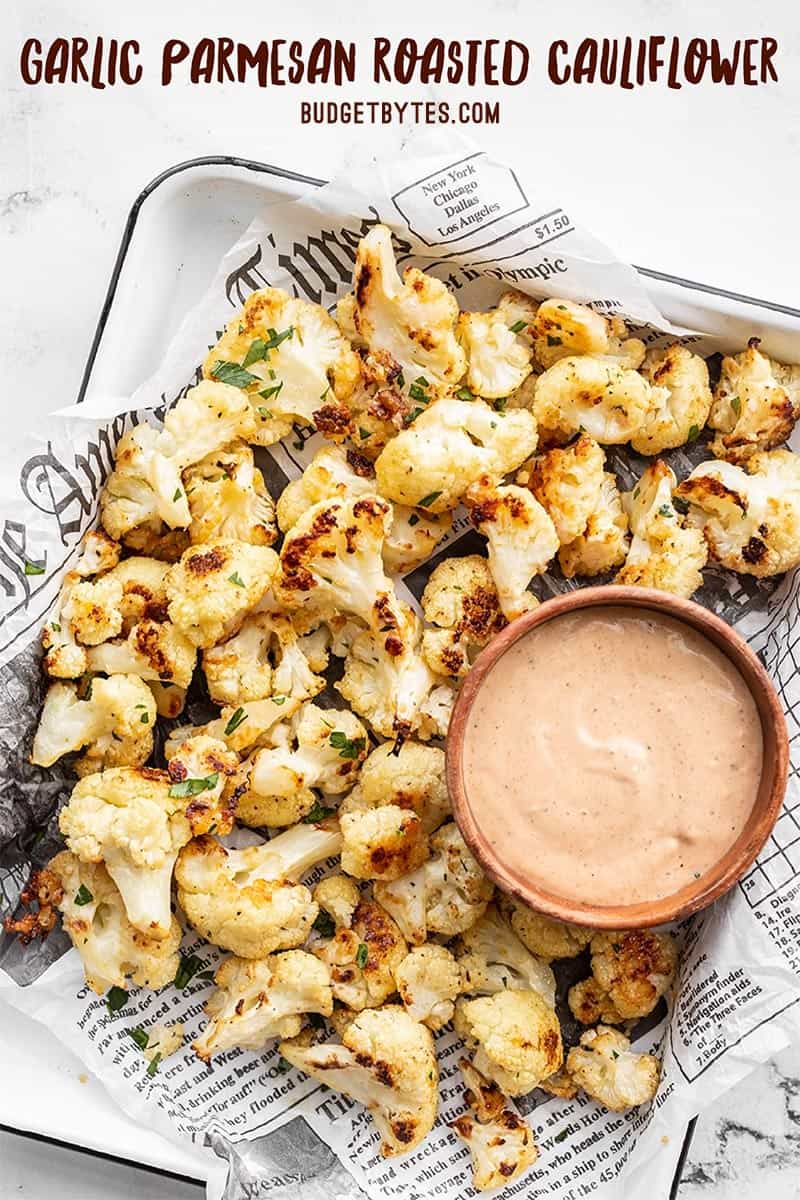 Garlic Parmesan Roasted Cauliflower on a tray with a bowl of dip, title text at the top