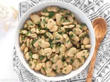 Marinated White Beans are a fast, easy, and versatile side dish that comes together in minutes. BudgetBytes.com
