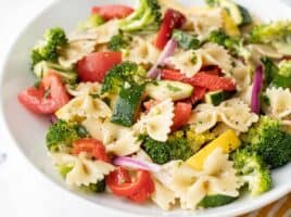 close up side view of a bowl of summer vegetable pasta salad