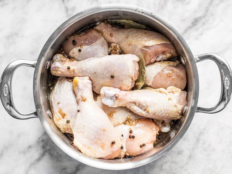 Chicken and marinade in pot ready to cook 