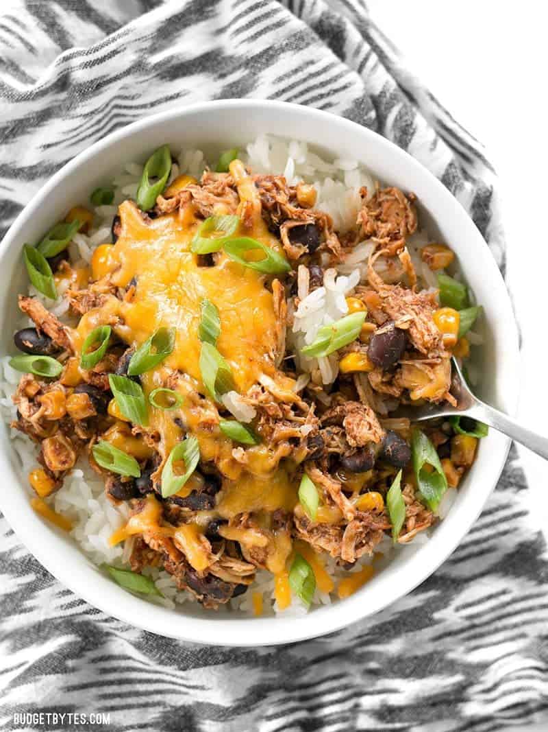 Close up of a Slow Cooker Taco Chicken Bowl with melted cheese and sliced green onions - easy menu plan