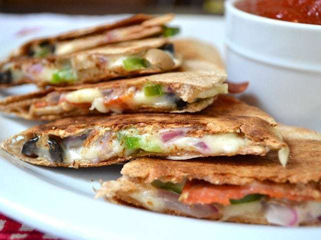 Close up of a Pizzadilla on a plate with a side of marinara 
