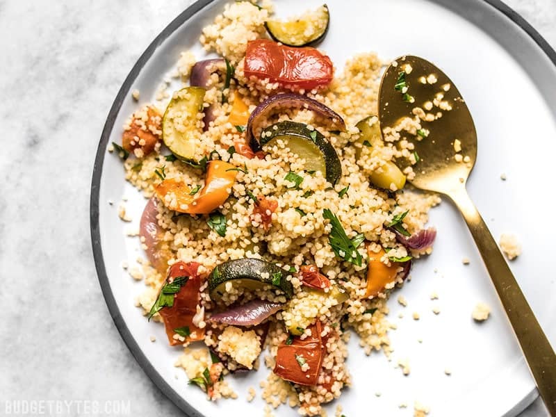 Roasted Vegetable Couscous is an easy side dish with complex flavor, with sweet roasted vegetables mixed with savory, fluffy couscous. Budgetbytes.com